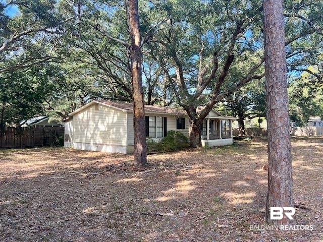 2411 Calloway Road Gulf Shores, AL 36542 - Photo 5 of 8 View of front of home with a sunroom and view of wooded area