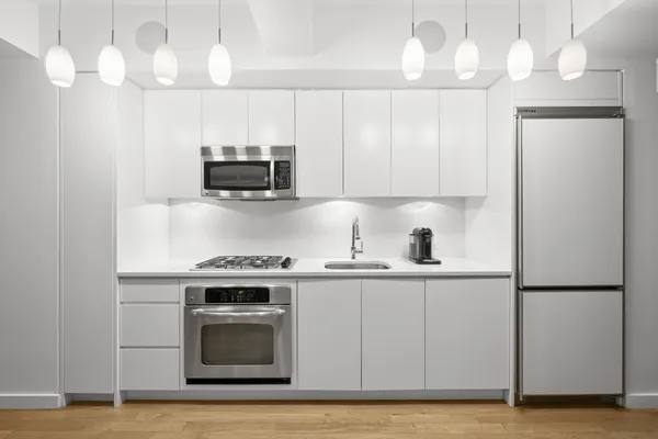 a kitchen with a stove and a refrigerator