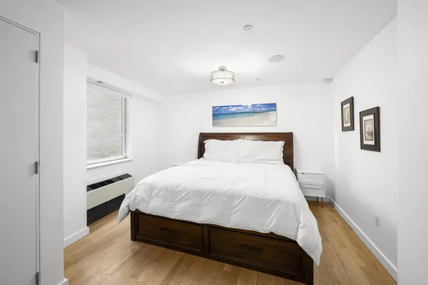 a bedroom with a bed and window