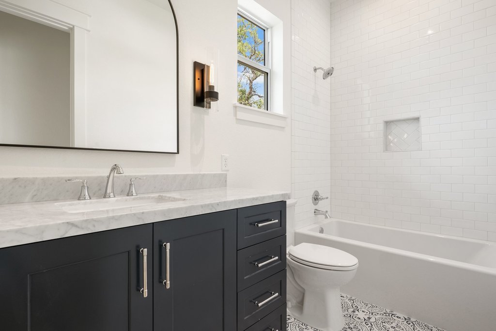 501 Ranchview Drive Johnson City, TX 78636 - Photo 18 of 28 a bathroom with a granite countertop toilet sink and mirror
