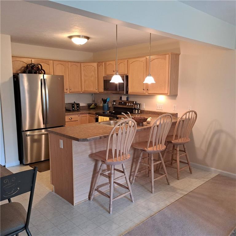 304 Acre Avenue Butler, PA 16001 - Photo 2 of 21 a kitchen with a table chairs refrigerator and microwave