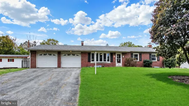 a view of a house with a yard and sitting area