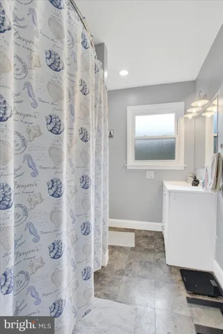 an empty room with wooden floor and entryway