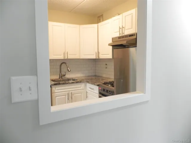 a kitchen with a sink cabinets and a window