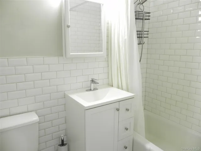 a view of a swimming pool with a table and chairs under an umbrella