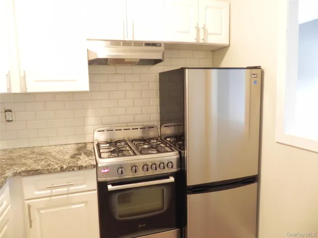 a close view of a stove top oven and refrigerator