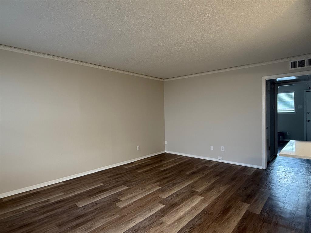 3624 Parkridge Drive, Unit 214 Dallas, TX 75234 - Photo 5 of 10 a view of room with wooden floor