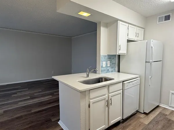 a kitchen with a sink and refrigerator