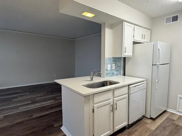 a kitchen with a sink and refrigerator