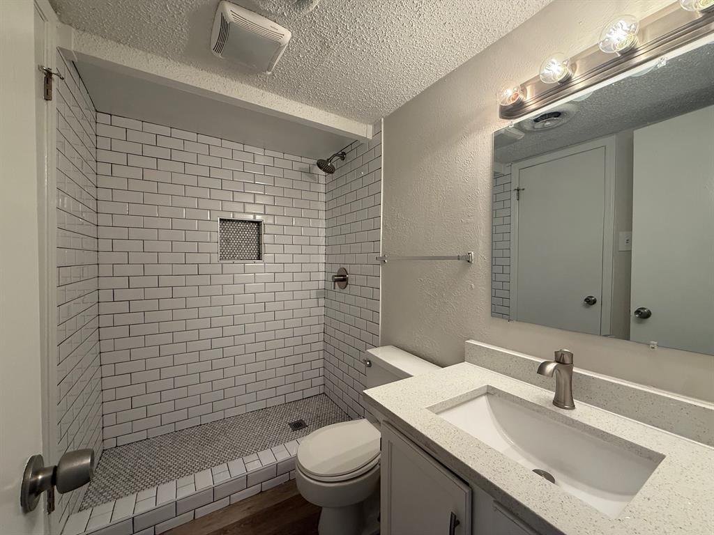 3624 Parkridge Drive, Unit 214 Dallas, TX 75234 - Photo 8 of 10 a bathroom with a sink a toilet and shower