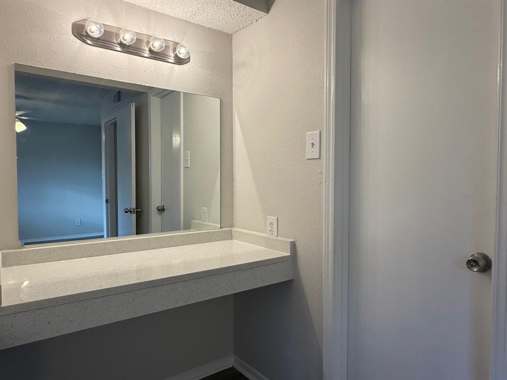 3624 Parkridge Drive, Unit 214 Dallas, TX 75234 - Photo 9 of 10 a bathroom with a sink and a mirror