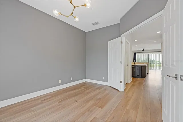 a view of a hallway with wooden floor and entryway