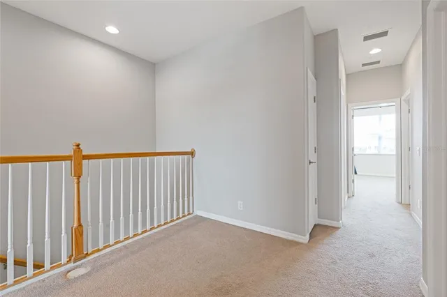 an empty room with wooden floor and closet area