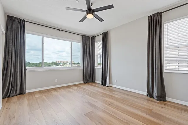 a bathroom with a granite countertop sink a mirror and shower