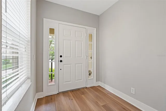 a view of an entryway with wooden floor