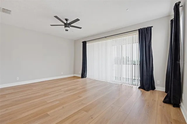 wooden floor in an empty room with a window