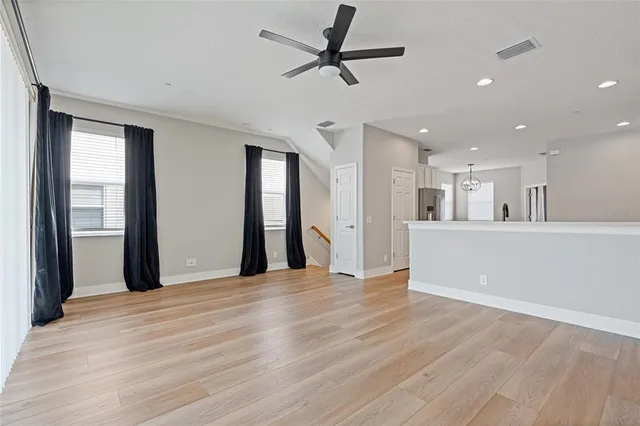 a view of a kitchen with a sink and a refrigerator