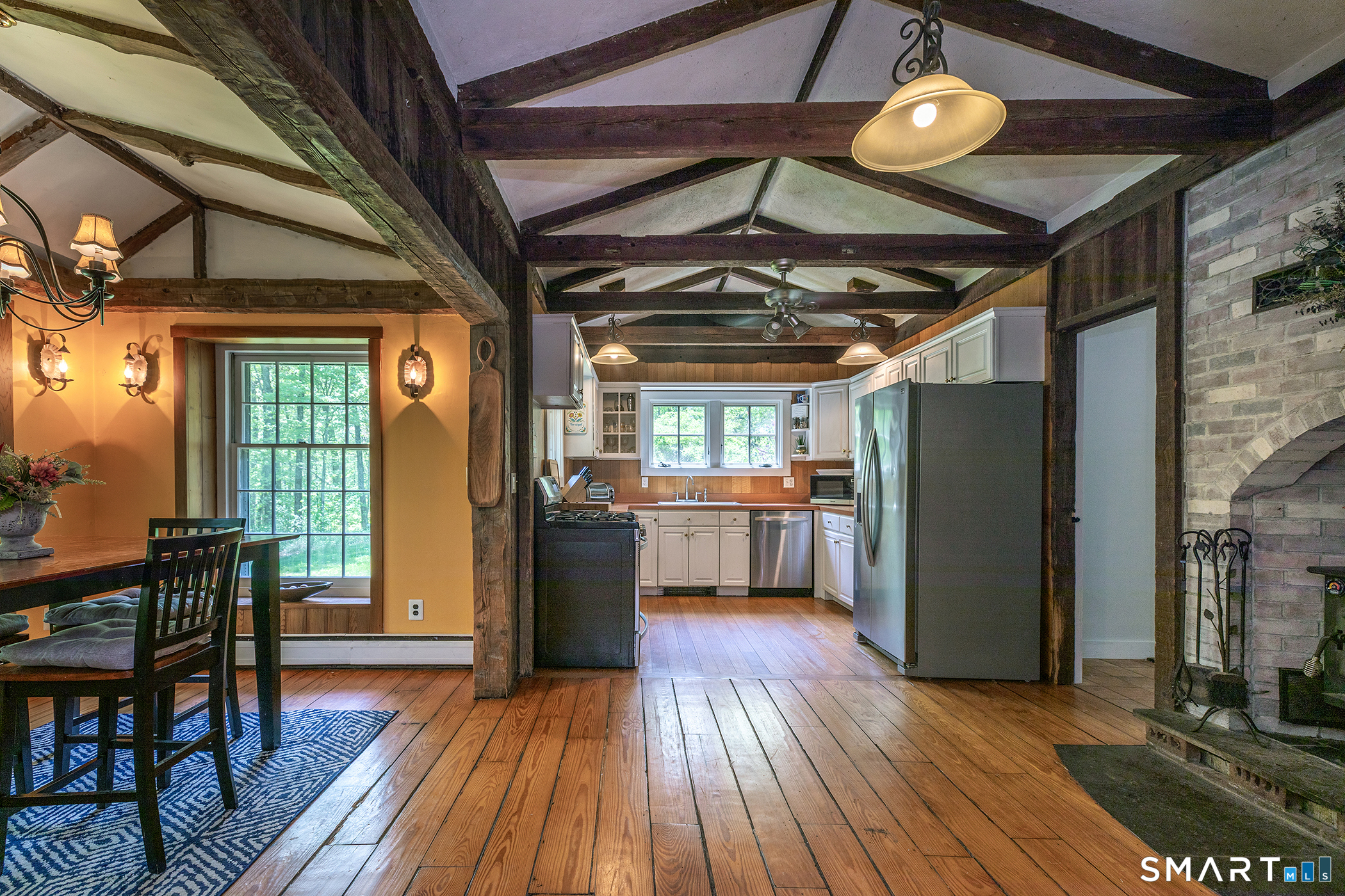 25 Bald Hill Road Kent, CT 06785 - Photo 4 of 38 This open-concept space blends the family room, kitchen, & dining area under cathedral ceilings & rustic exposed beams. Perfectly airy and inviting for gatherings or cozy nights.