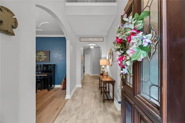 a hallway with beautiful flowers and wooden floor
