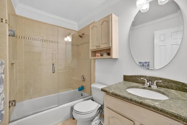 a bathroom with a granite countertop sink a toilet and bathtub
