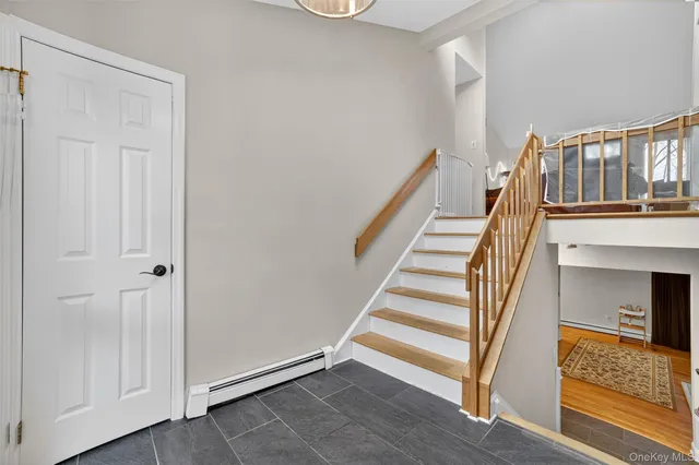 a view of entryway and hall with wooden floor