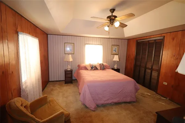 a bedroom with a bed and a chandelier