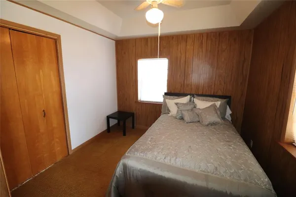 a bed room with a bed and a window