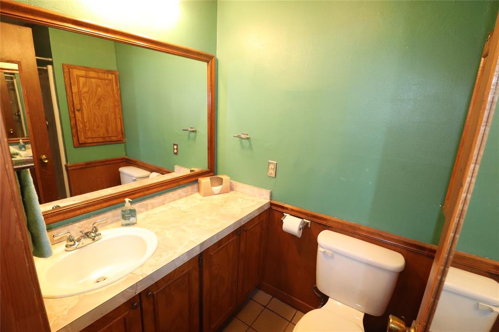 2553 Brixey Road Henrietta, TX 76365 - Photo 32 of 32 a bathroom with a sink and a mirror