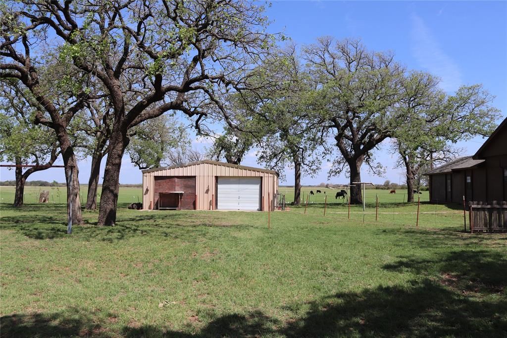 2553 Brixey Road Henrietta, TX 76365 - Photo 4 of 32 a house that has a tree in front of it