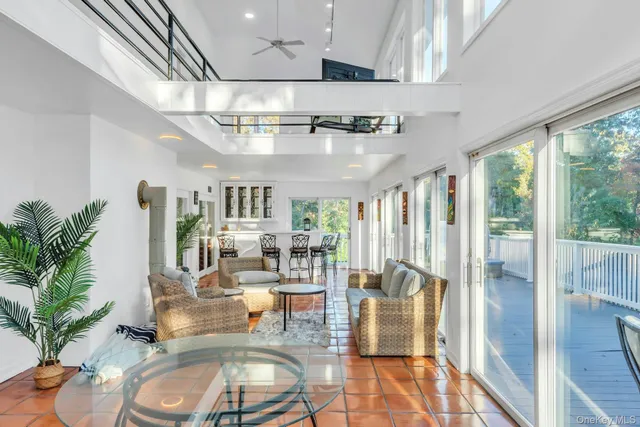 a living room with lots of furniture and a potted plant
