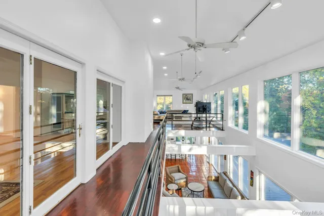 a view of a dining room with furniture a chandelier and wooden floor