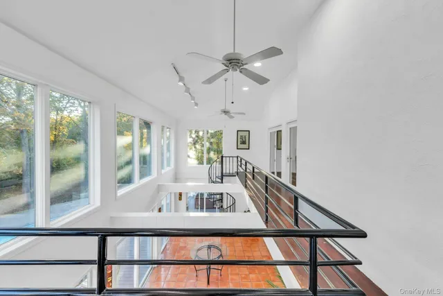 a view of a living room with furniture window and ceiling fan