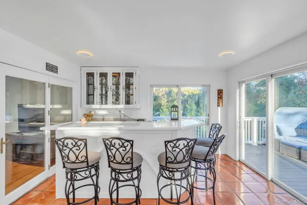 a dining area with furniture and a large window