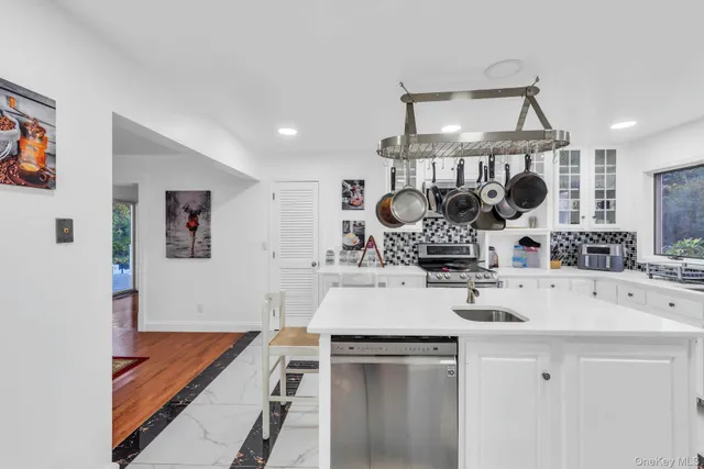 a kitchen with a sink a stove and cabinets