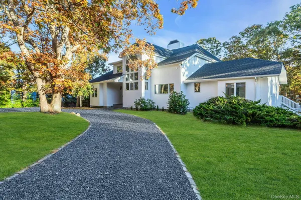 a view of a house with yard and tree s