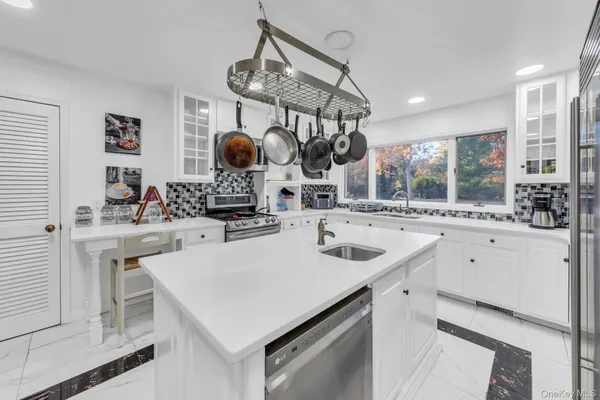a kitchen with a sink a stove and cabinets
