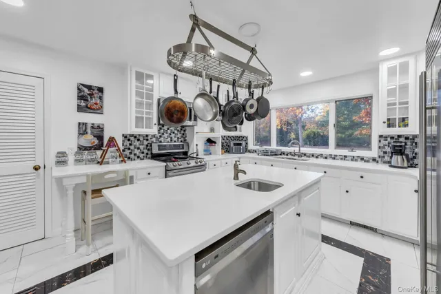 a kitchen with a sink a stove and cabinets