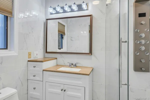 a bathroom with a toilet sink and mirror