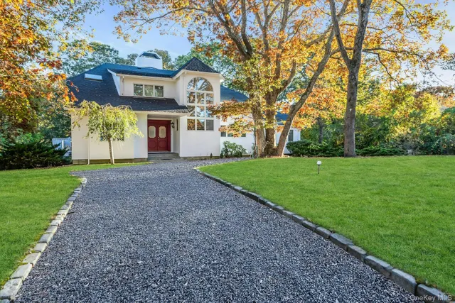 a front view of a house with yard and green space