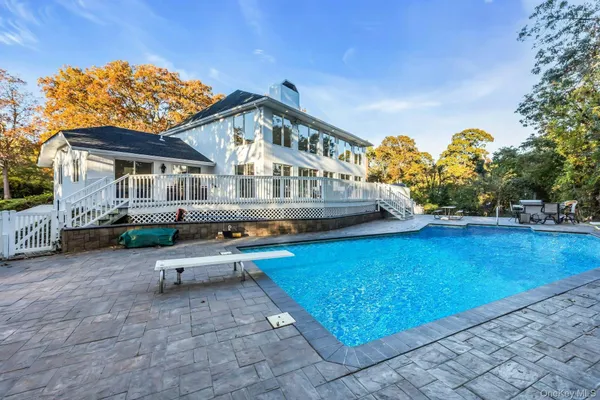 a front view of a house with a garden and trees