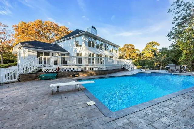 a front view of a house with a garden and trees
