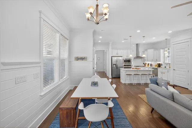 a living room with kitchen island furniture and a dining table