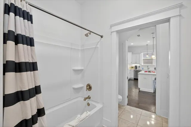 a bathroom with a bathtub and shower