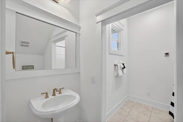 a bathroom with a sink and mirror