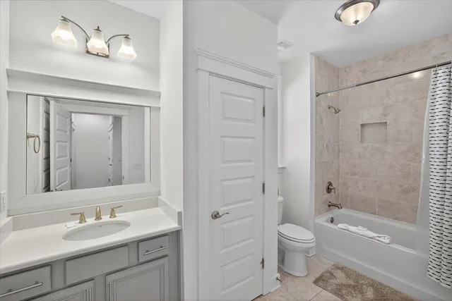 a bathroom with a granite countertop toilet a sink and a bathtub