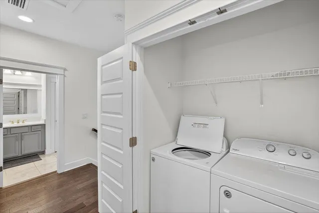 a view of storage and utility room with closet dryer and washer