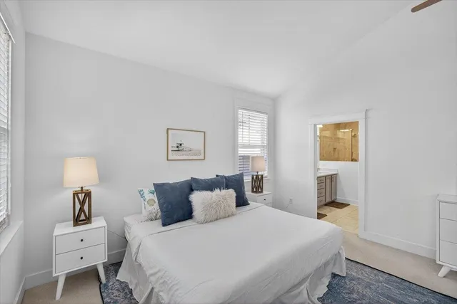 a bedroom with bed and a night stand