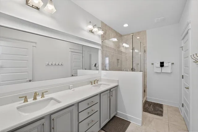 a bathroom with a sink double vanity and a shower