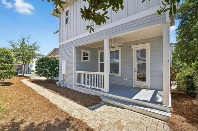 a view of a house with a yard and sitting area
