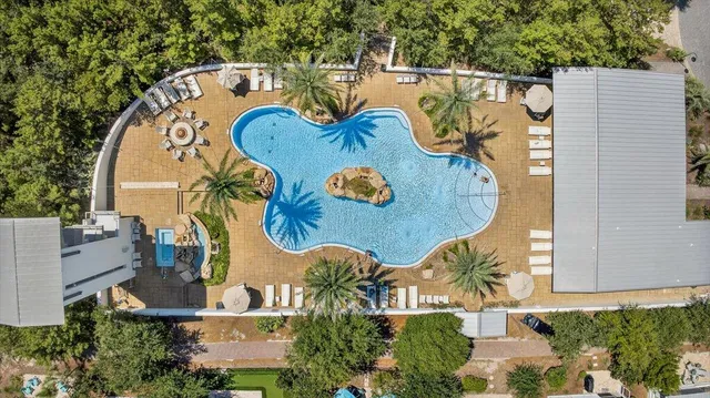 an aerial view of a house with garden space and swimming pool